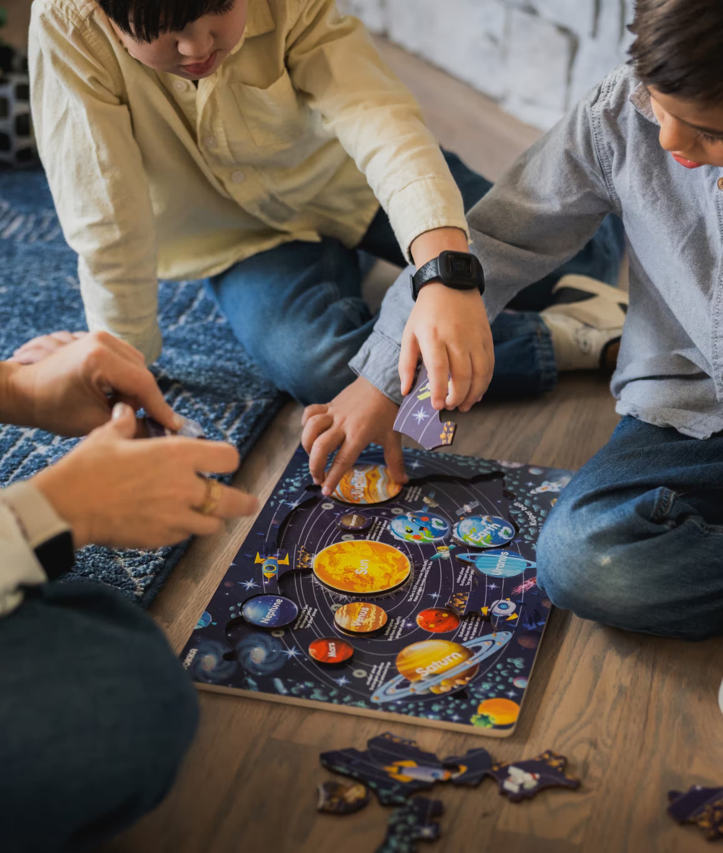 Children working together on a solar-system puzzle